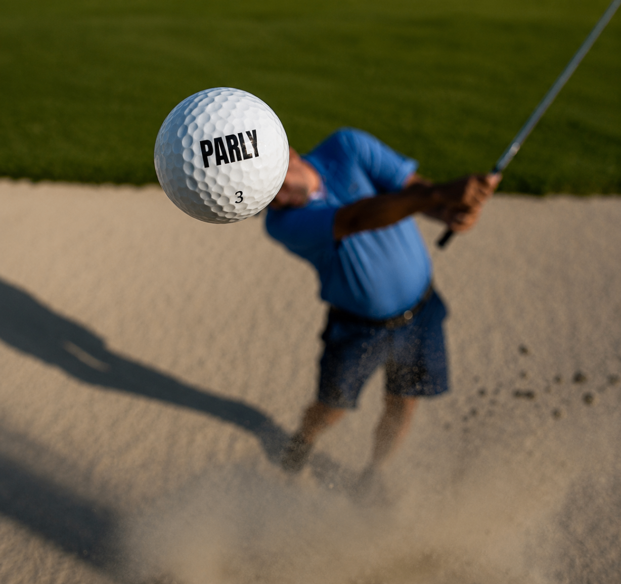 PARLY golf ball exploding out of a greenside bunker